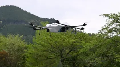 The drone, carrying essential medicines, soars above the landscape on its delivery route.